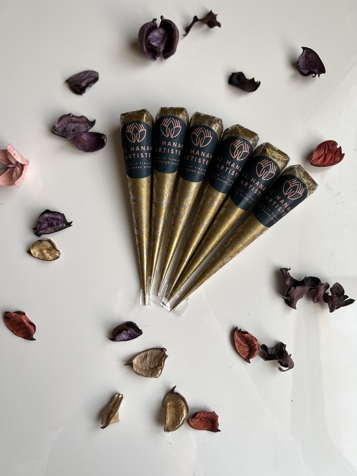 Fresh organic henna cones arranged with dried botanicals by Al Hanah Artiste